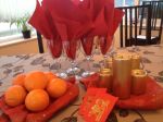 You can see the Oranges, Ang Pow, gold candles, and red napkins - very festive!